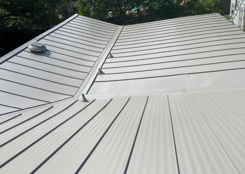 Solar attic fan installed on a metal roof for Roof Ventilation in Prospect Heights